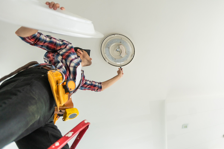 Handyman fixing a light fixture