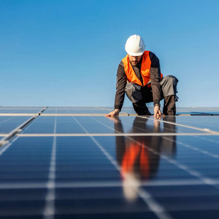 Solar panel installer installing solar panels