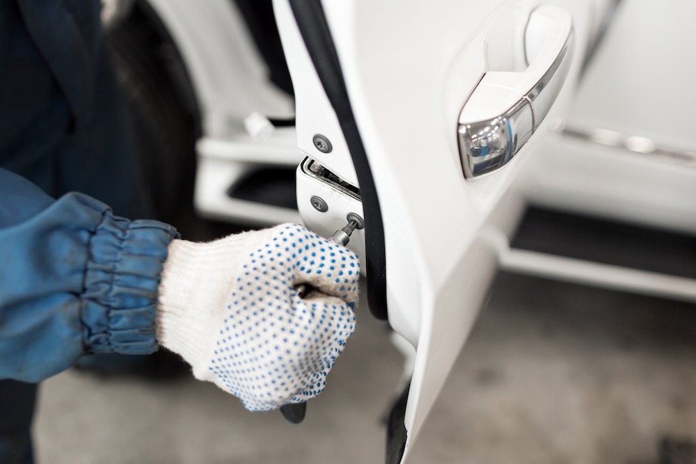 Insured locksmith changing a car lock