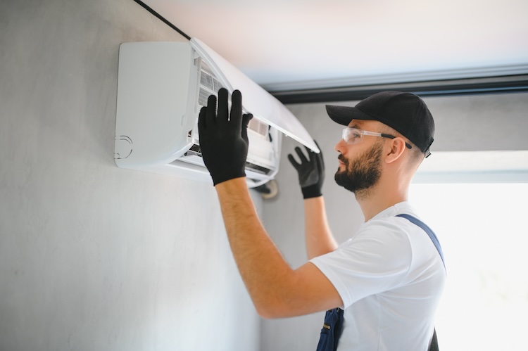 Air conditioner installer installing a unit