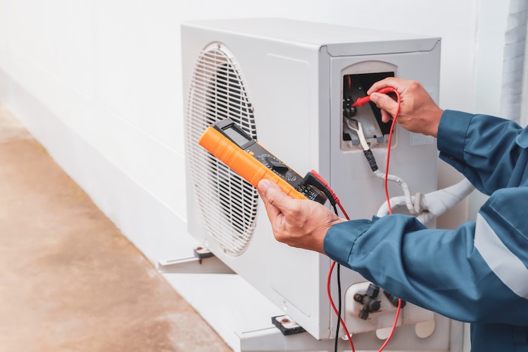 Air con installer performing maintenance