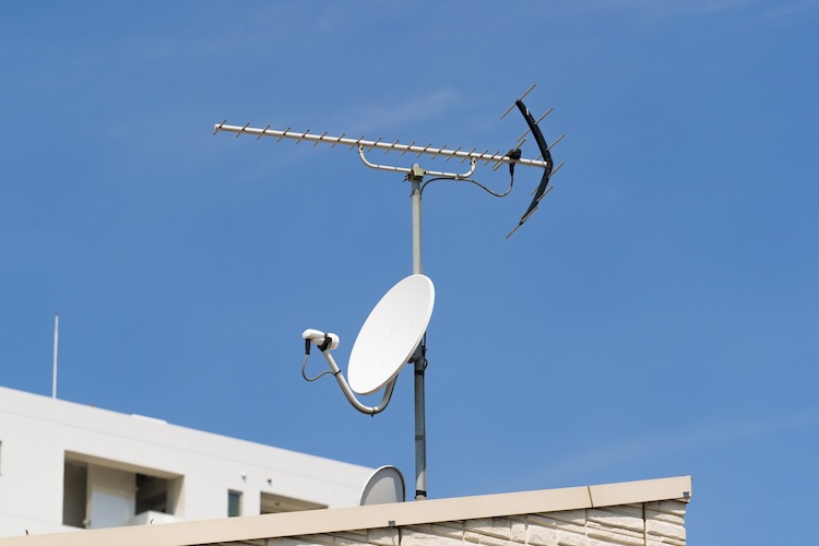 White dish antenna on a roof