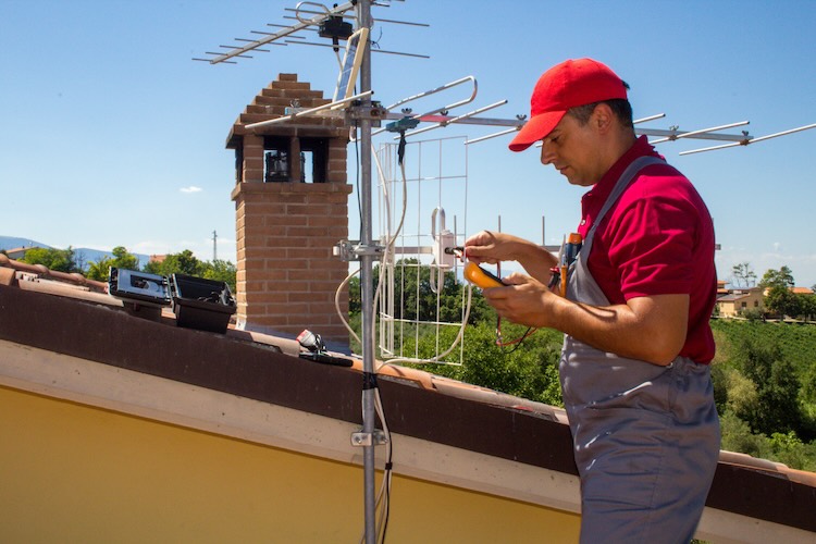 Antenna installer installing an antenna