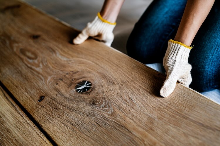 Flooring contractor man installing wooden floor