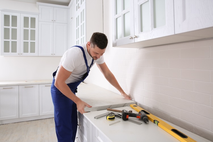 Kitchen fitter installing a counter